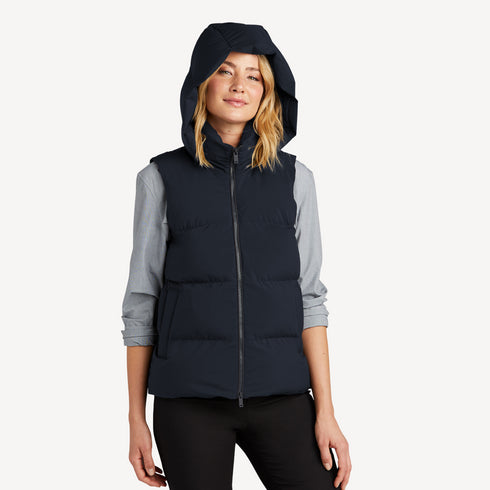 Front view of women’s navy waterproof puffer vest with hoodie on model – Louvóre apparel